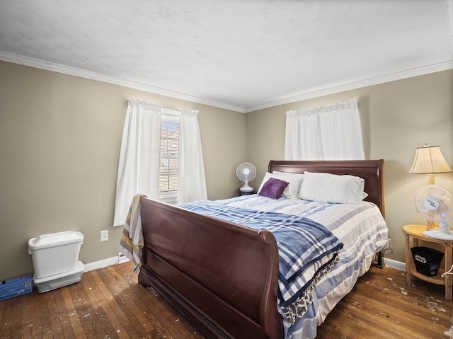 bedroom featuring wood-type flooring, baseboards, and crown molding