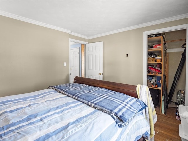 bedroom with a closet, wood finished floors, and crown molding