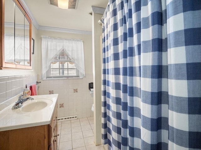 bathroom featuring a wainscoted wall, vanity, tile walls, ornamental molding, and tile patterned floors