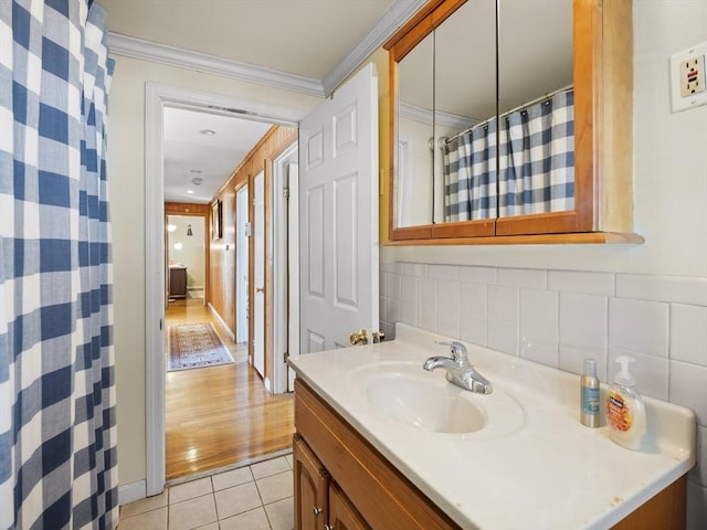 bathroom featuring crown molding, tile walls, a shower with curtain, vanity, and tile patterned flooring