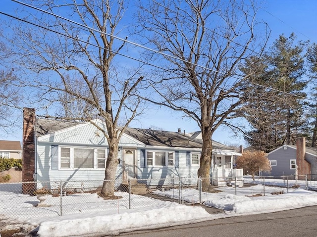 view of front of house featuring a fenced front yard and a chimney