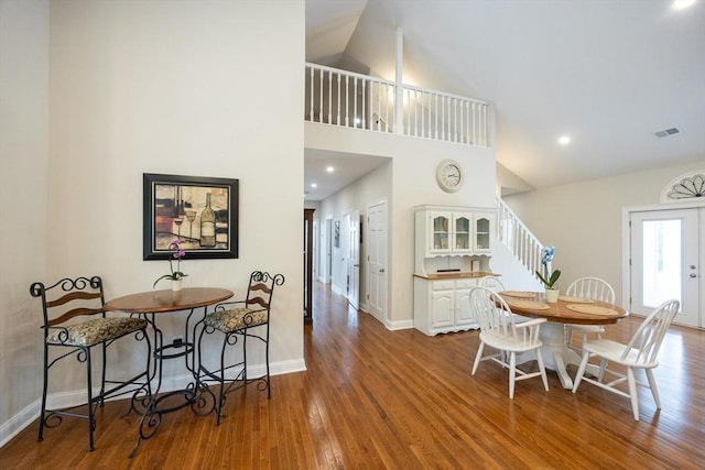 977 E St, Wrentham, MA 02093 - dining space with wood finished floors, stairs, high vaulted ceiling, and recessed lighting
