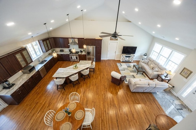 977 E St, Wrentham, MA 02093 - living area featuring high vaulted ceiling, plenty of natural light, dark wood finished floors, a ceiling fan, and recessed lighting