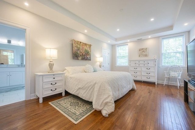 977 E St, Wrentham, MA 02093 - bedroom featuring dark wood-type flooring, multiple windows, ensuite bathroom, a tray ceiling, and recessed lighting