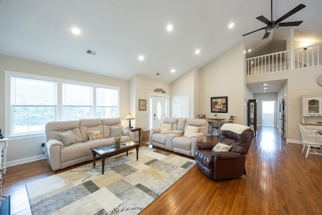 977 E St, Wrentham, MA 02093 - living area featuring wood finished floors, healthy amount of natural light, high vaulted ceiling, a ceiling fan, and recessed lighting