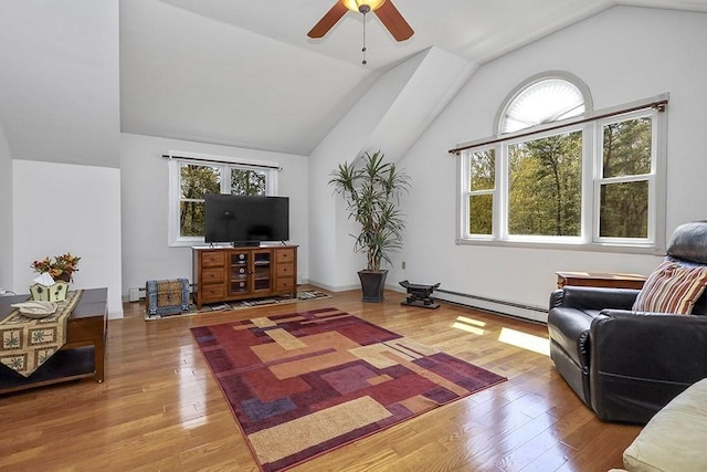 living area featuring vaulted ceiling, baseboard heating, a ceiling fan, and wood finished floors