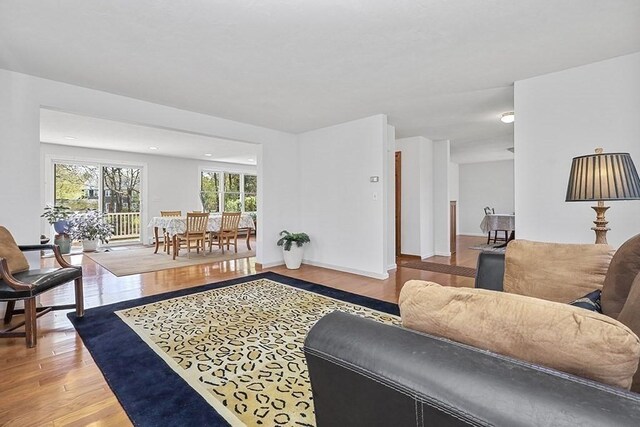 living area with baseboards and light wood-style flooring
