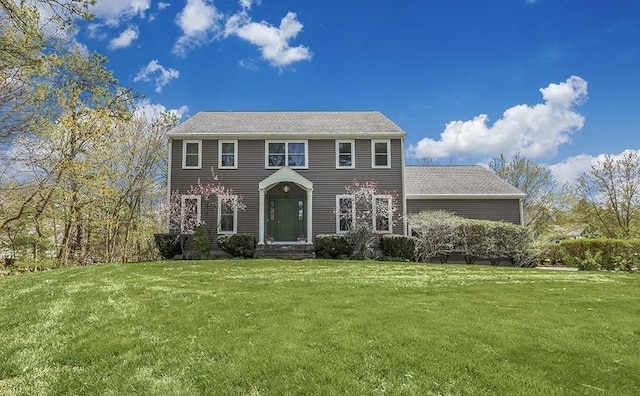 colonial inspired home featuring a front lawn