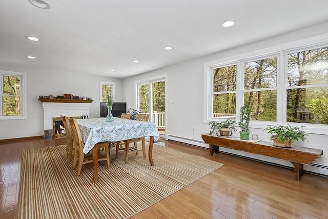 dining room featuring light wood-type flooring, recessed lighting, and baseboard heating