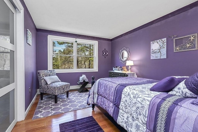 bedroom featuring baseboards and wood finished floors