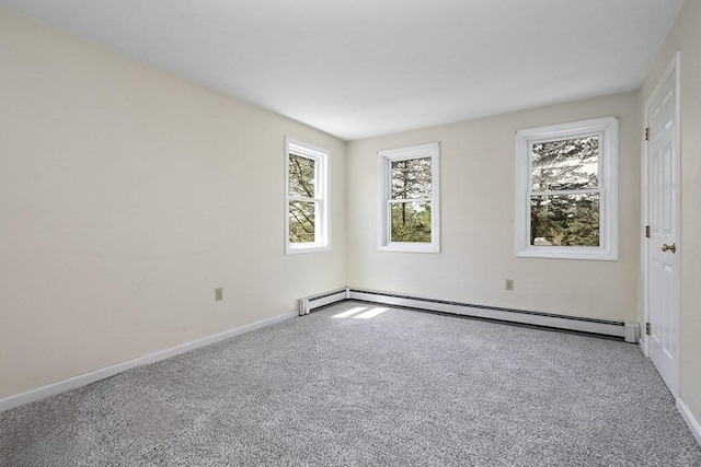 carpeted spare room with baseboards, plenty of natural light, and a baseboard radiator