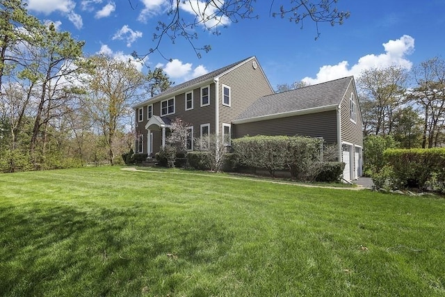 exterior space with a yard and an attached garage