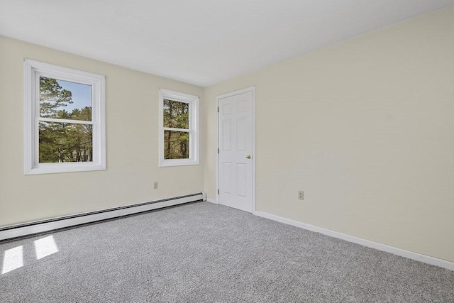 empty room with carpet flooring, baseboards, and baseboard heating