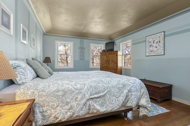 bedroom with baseboards and wood finished floors
