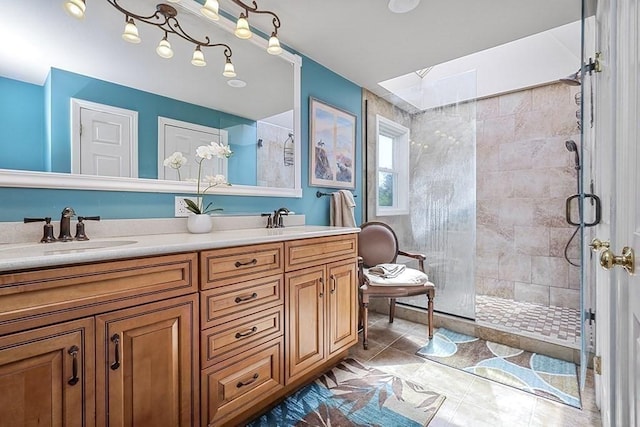 bathroom with double vanity, a sink, and a tile shower