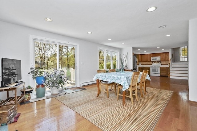 dining room with stairway, hardwood / wood-style flooring, and recessed lighting
