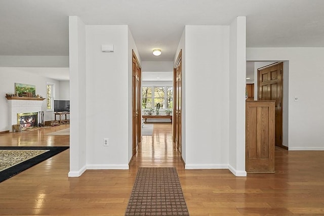 corridor featuring baseboards and wood finished floors