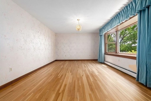 24 Flume Rd, Gloucester, MA 01930 - spare room featuring light wood-style floors, a chandelier, baseboard heating, and baseboards