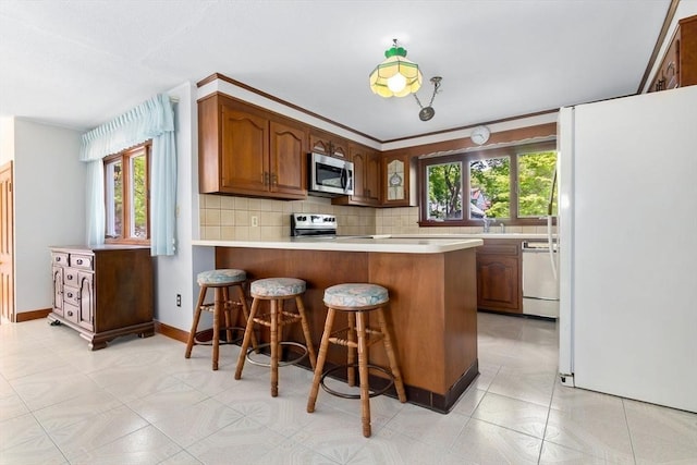 24 Flume Rd, Gloucester, MA 01930 - kitchen featuring white appliances, plenty of natural light, backsplash, and light countertops