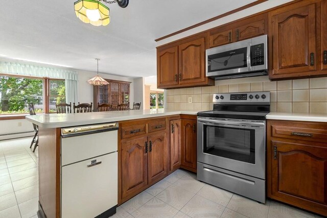 24 Flume Rd, Gloucester, MA 01930 - kitchen with stainless steel appliances, a peninsula, light countertops, and brown cabinets
