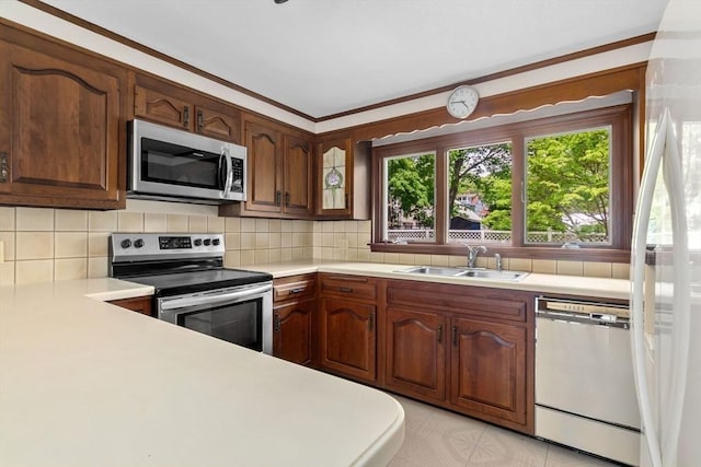 24 Flume Rd, Gloucester, MA 01930 - kitchen featuring stainless steel appliances, a sink, light countertops, and backsplash