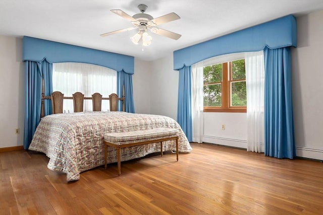 24 Flume Rd, Gloucester, MA 01930 - bedroom with a baseboard heating unit, wood finished floors, baseboards, and a ceiling fan