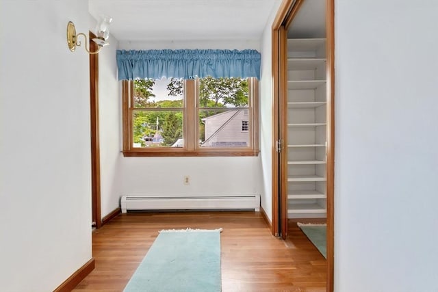 24 Flume Rd, Gloucester, MA 01930 - hallway featuring baseboard heating, wood finished floors, and baseboards