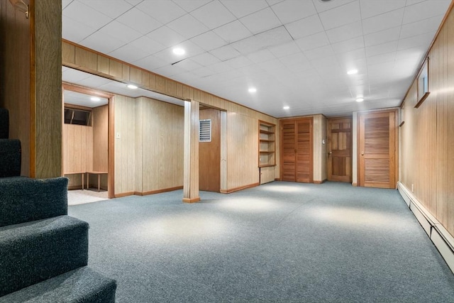 24 Flume Rd, Gloucester, MA 01930 - finished below grade area featuring a baseboard radiator, carpet, wooden walls, baseboards, and recessed lighting