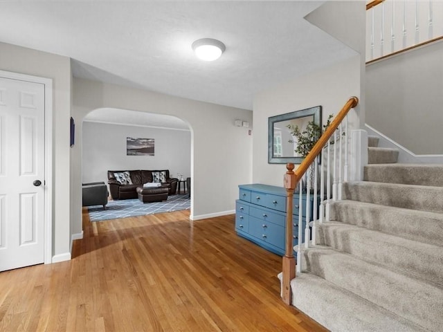 41 Nancy Dr, Ashland, MA 01721 - entrance foyer featuring arched walkways, wood finished floors, and stairs