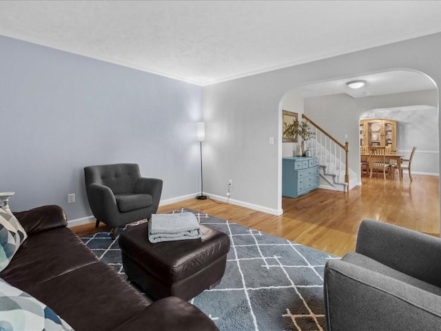 41 Nancy Dr, Ashland, MA 01721 - living room featuring arched walkways, wood finished floors, and stairs