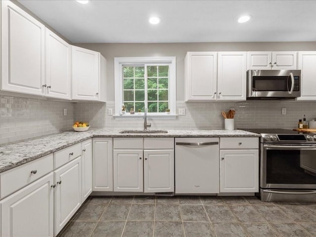 41 Nancy Dr, Ashland, MA 01721 - kitchen featuring stainless steel appliances, white cabinets, backsplash, light stone countertops, and recessed lighting