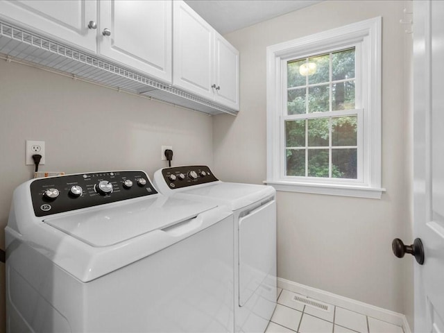 41 Nancy Dr, Ashland, MA 01721 - washroom featuring cabinet space, washing machine and clothes dryer, plenty of natural light, and light tile patterned flooring