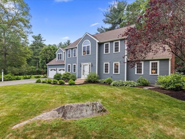 41 Nancy Dr, Ashland, MA 01721 - colonial home with driveway, a front yard, an attached garage, and a shingled roof
