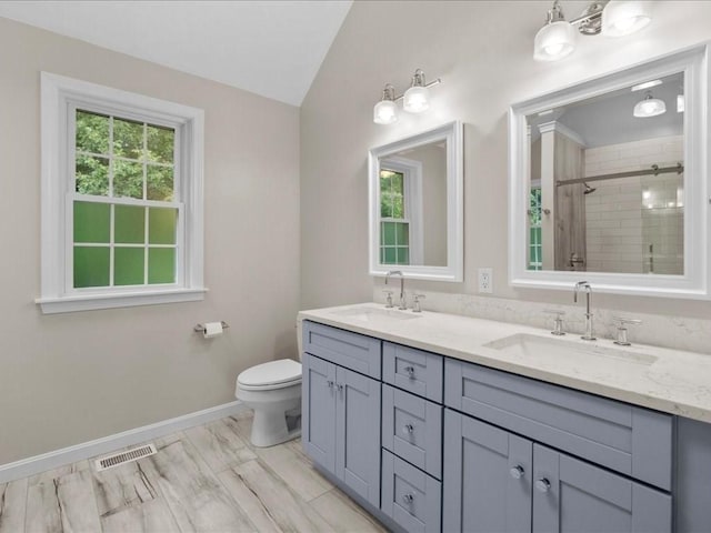 41 Nancy Dr, Ashland, MA 01721 - bathroom featuring double vanity, a tile shower, and vaulted ceiling