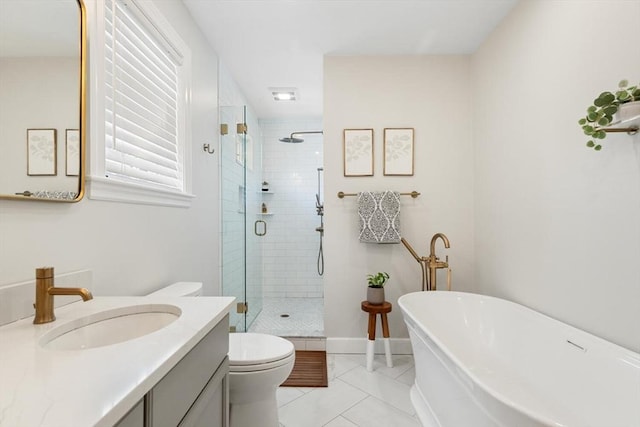 full bathroom with baseboards, a freestanding bath, a stall shower, tile patterned floors, and vanity