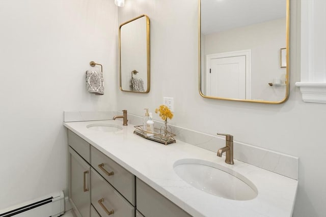 full bath featuring double vanity, a baseboard radiator, and a sink