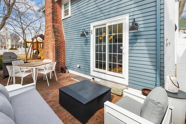 view of patio with outdoor dining area, fence, grilling area, and an outdoor hangout area