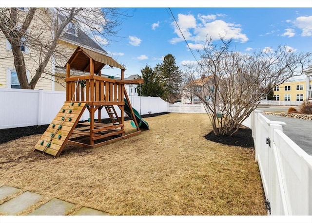 view of jungle gym with a lawn and a fenced backyard