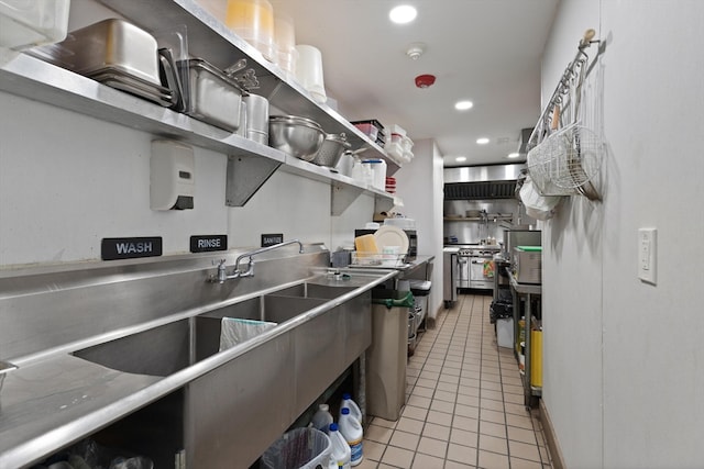 kitchen featuring stainless steel counters and light tile floors