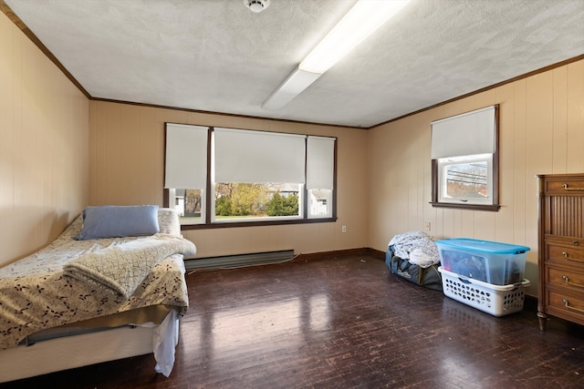 bedroom featuring crown molding, baseboard heating, dark hardwood / wood-style floors, and a textured ceiling