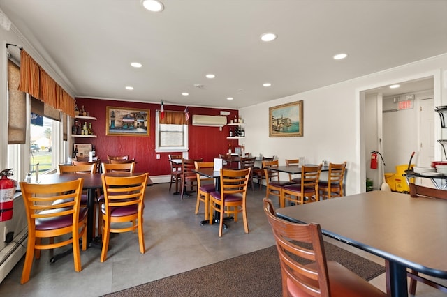 dining room featuring an AC wall unit and baseboard heating