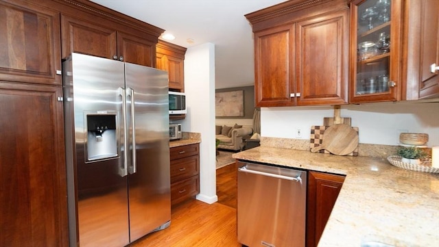 90 Braley Rd, Freetown, MA 02717 - kitchen with stainless steel appliances, light wood-type flooring, glass insert cabinets, light stone countertops, and recessed lighting