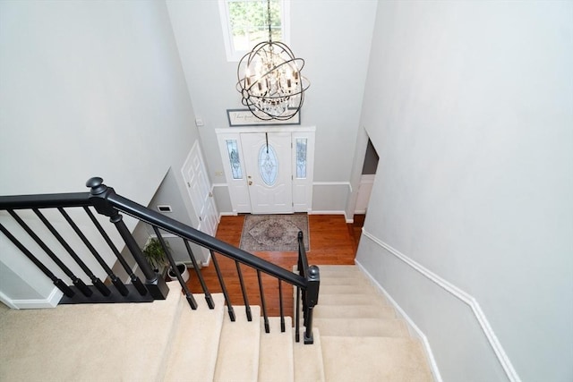 90 Braley Rd, Freetown, MA 02717 - stairs with a chandelier, a towering ceiling, and wood finished floors
