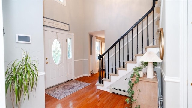 90 Braley Rd, Freetown, MA 02717 - entryway featuring a baseboard heating unit, wood finished floors, stairs, and a high ceiling