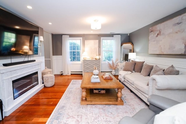 90 Braley Rd, Freetown, MA 02717 - living room featuring a high end fireplace, wood finished floors, a baseboard radiator, wainscoting, and recessed lighting