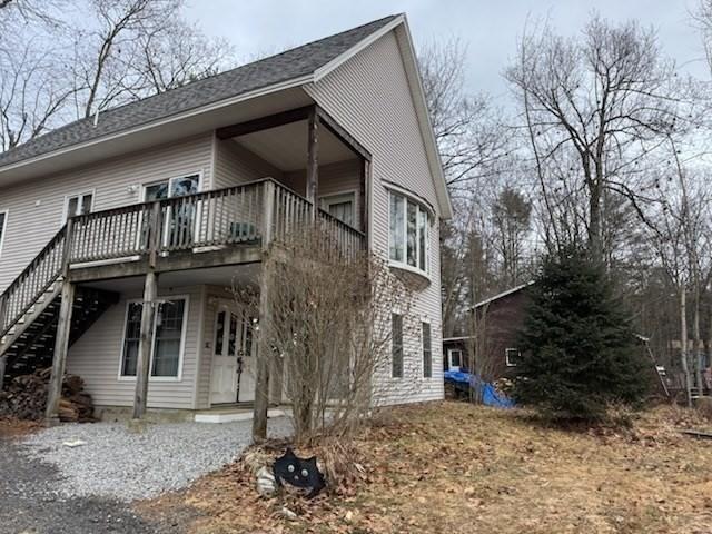 view of side of property featuring a balcony