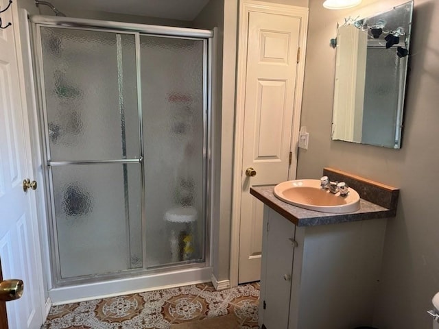 bathroom featuring tile patterned flooring, vanity, and a shower with shower door