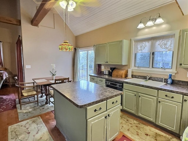 kitchen with ceiling fan, sink, hanging light fixtures, a kitchen island, and green cabinetry