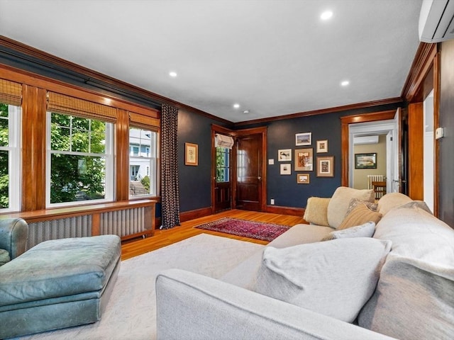 living area with radiator, ornamental molding, plenty of natural light, recessed lighting, and baseboards