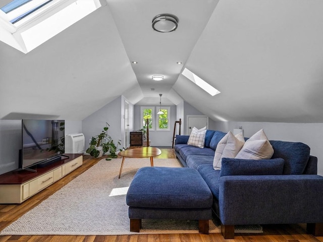 living area with a skylight, wood finished floors, and vaulted ceiling